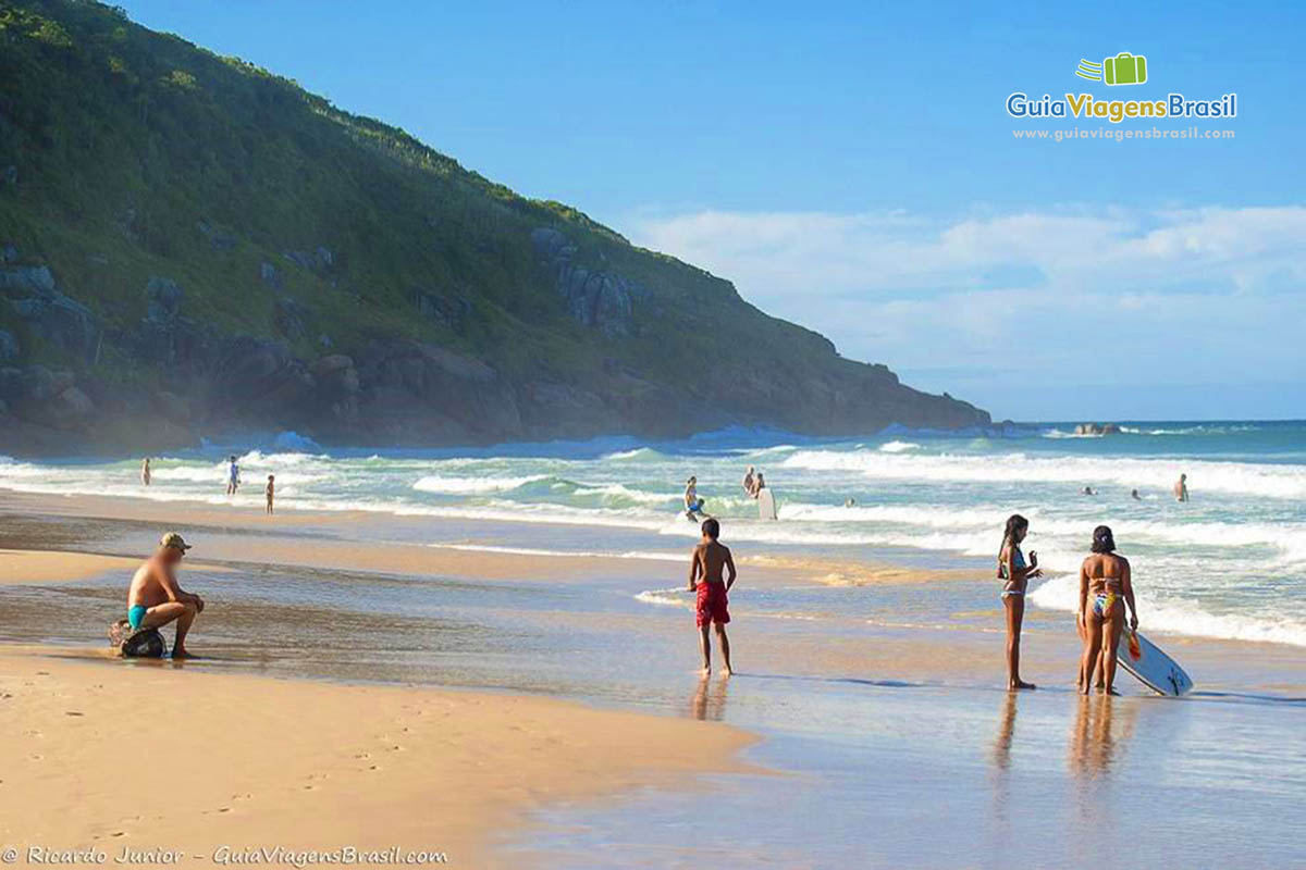 Imagem de crianças na beira da Praia Ingleses.