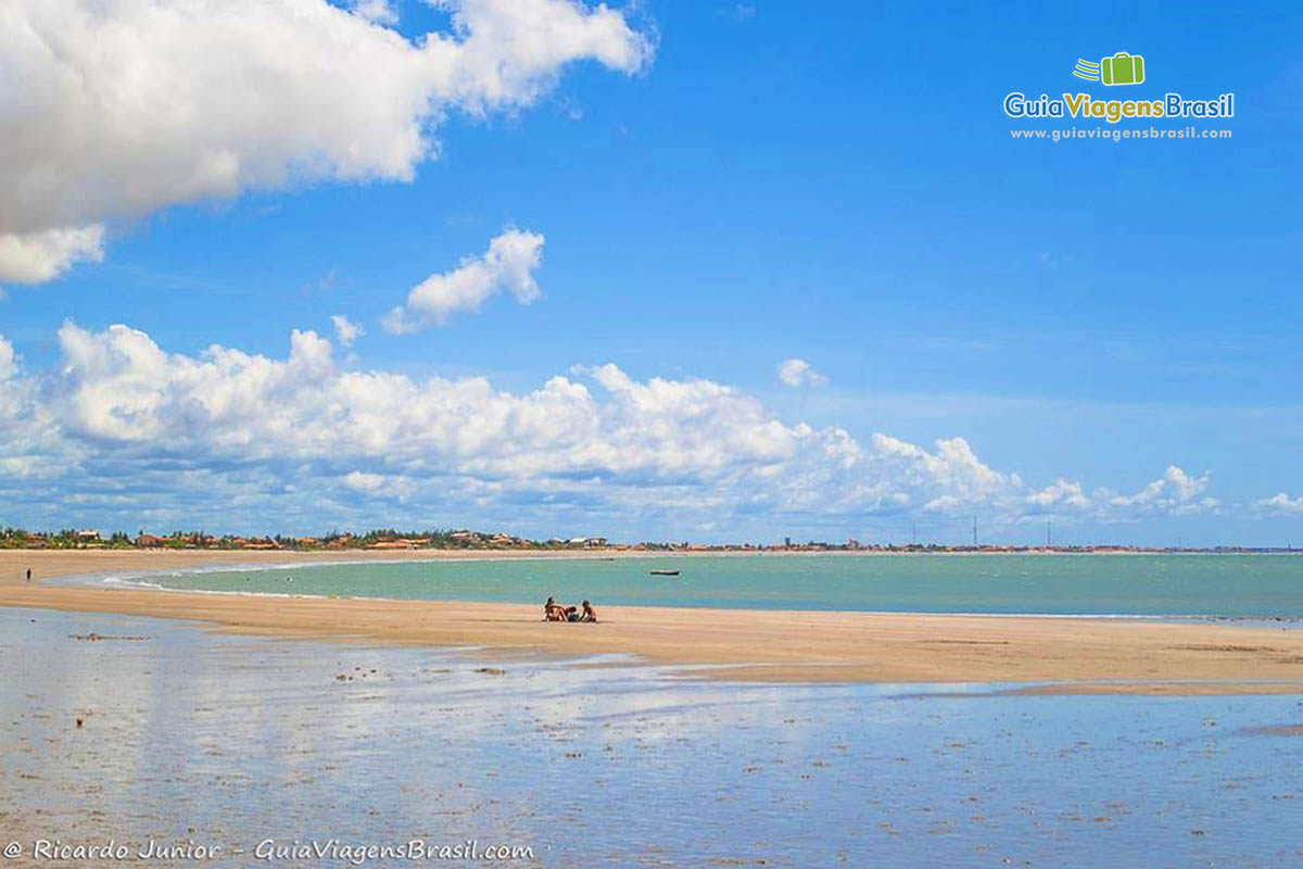 Imagem de turistas nas águas cristalinas da piscina natural da Praia do Coqueiro.