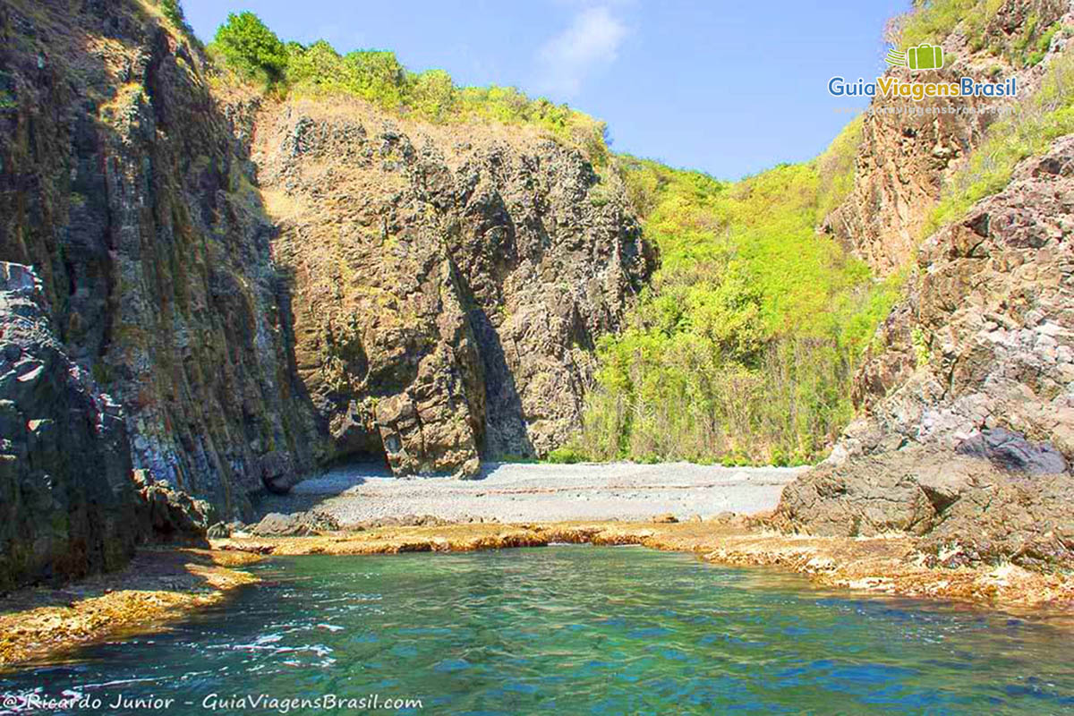 Imagem de piscina natural formada entre pedras, em Fernando de Noronha, Pernambuco, Brasil.