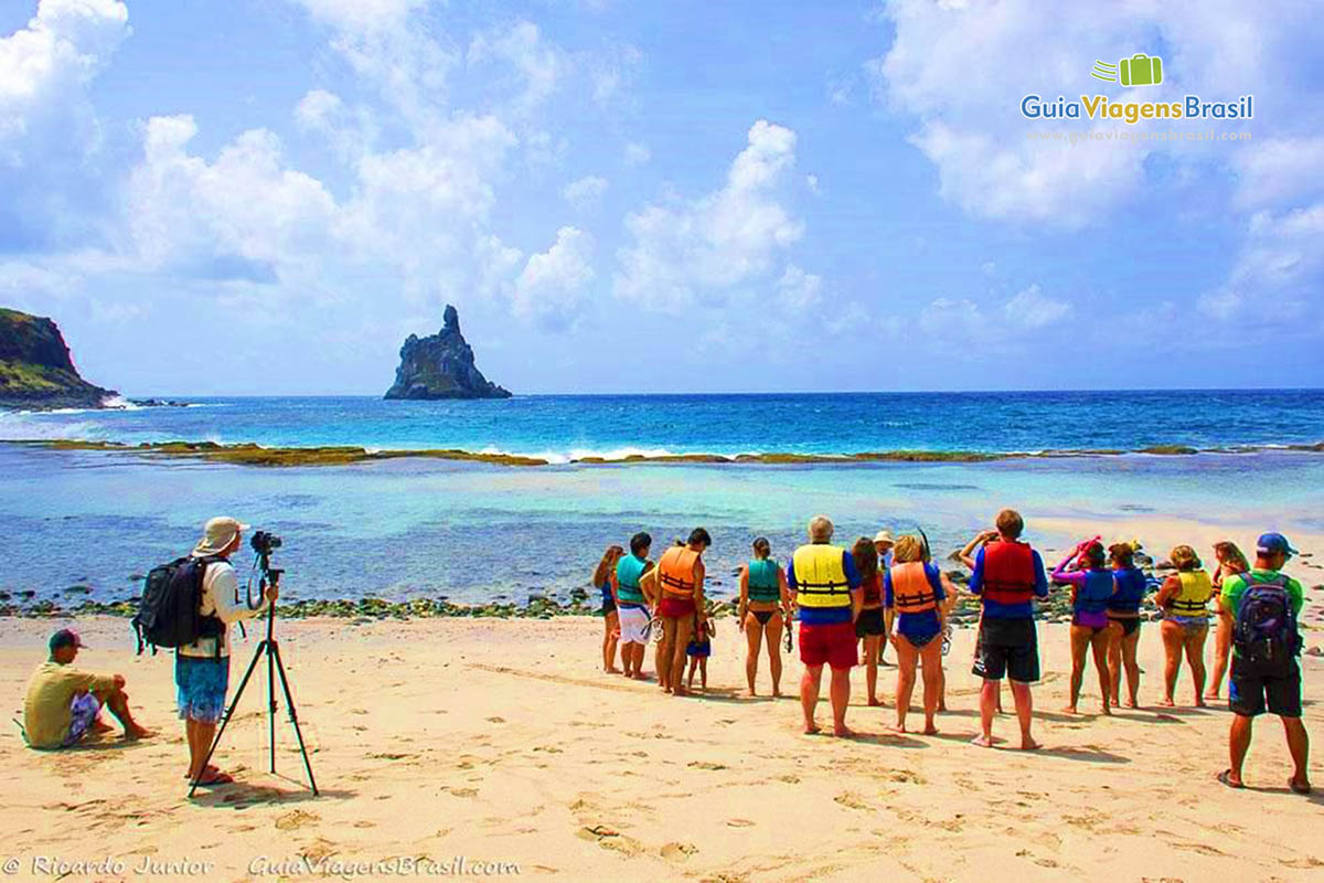 Imagem de turistas se preparando para mergulhar na Praia da Atalaia, em Fernando de Noronha, Pernambuco, Brasil.