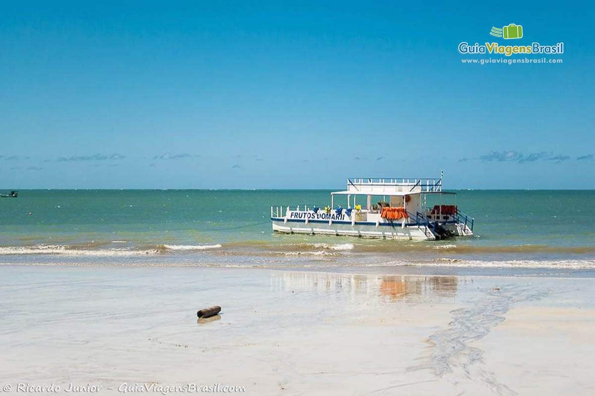 Imagem do barco de passeio no mar calmo da Praia de Maragogi.