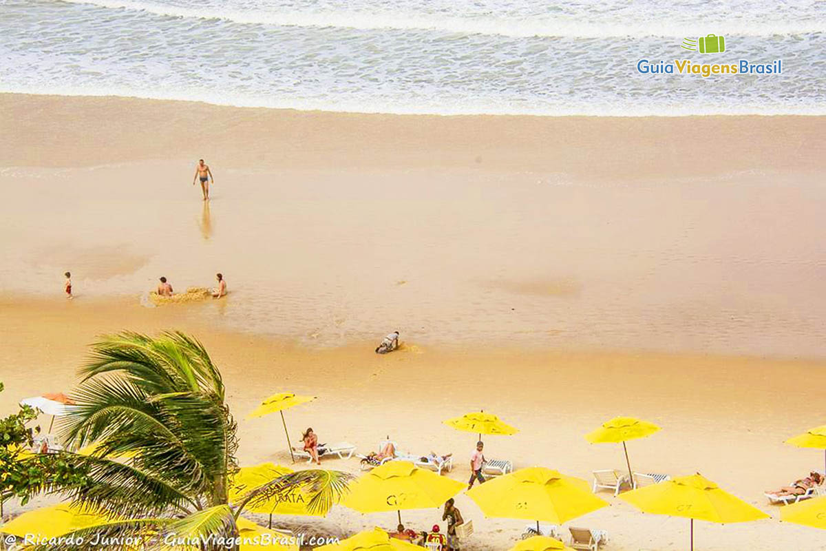 Imagem de turistas curtindo a praia.