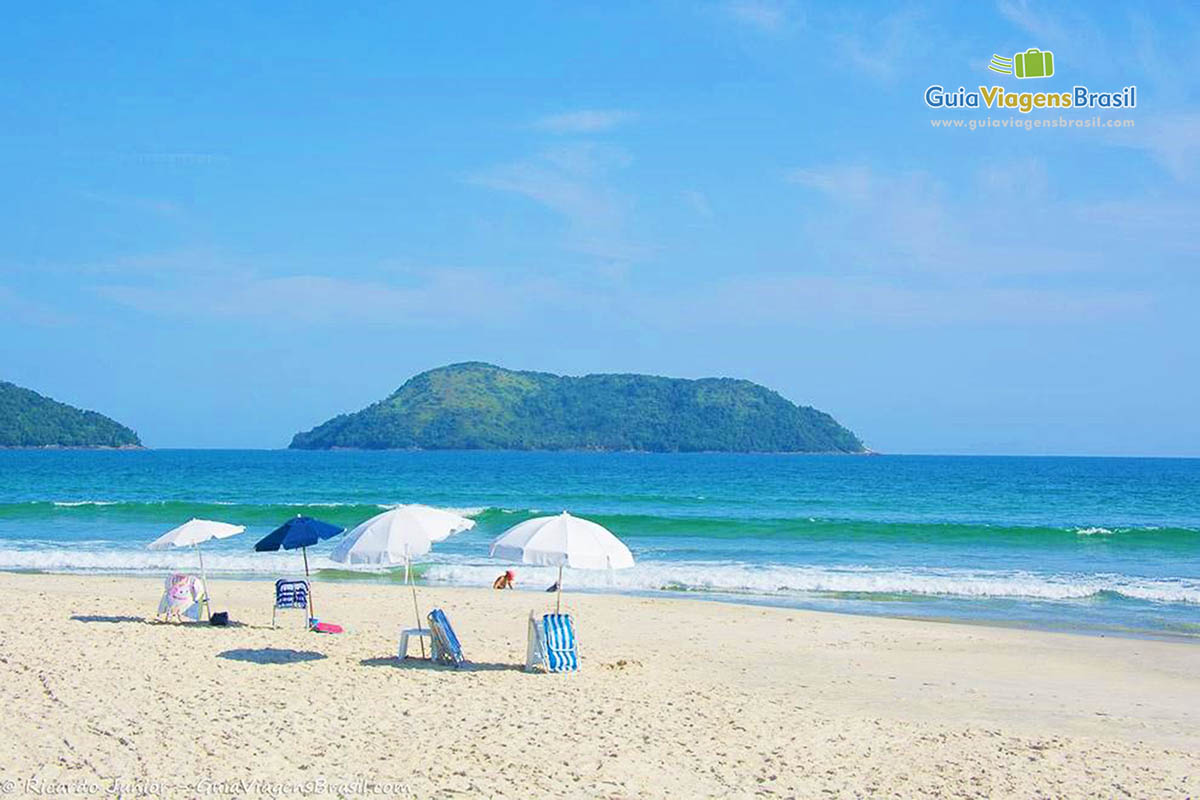 Imagem de três guarda sol na linda praia de São Sebastião.