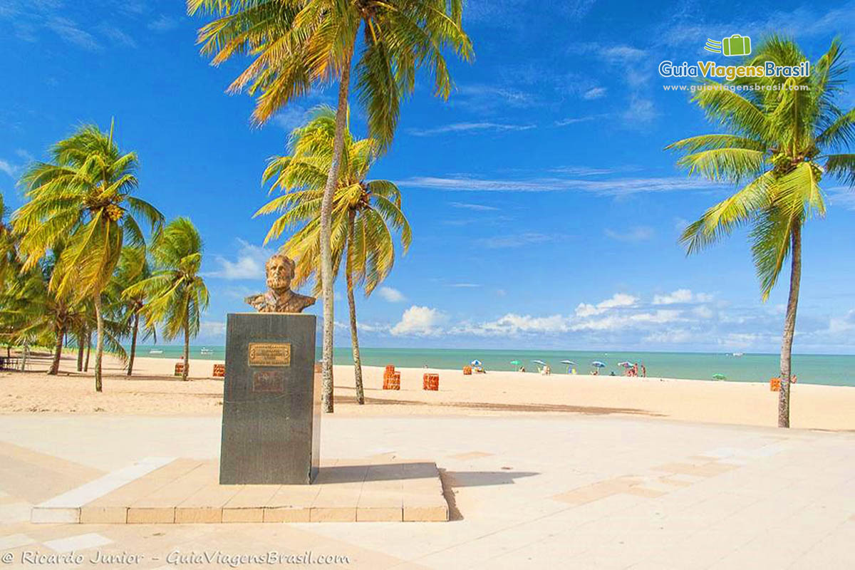 Imagem de um monumento no calçadão da praia.