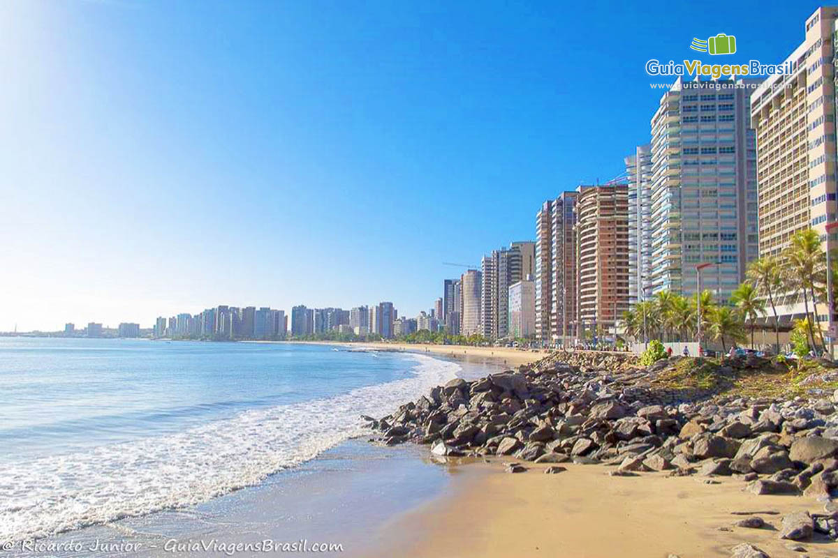 Imagem da praia e prédios da orla da Praia do Centro.