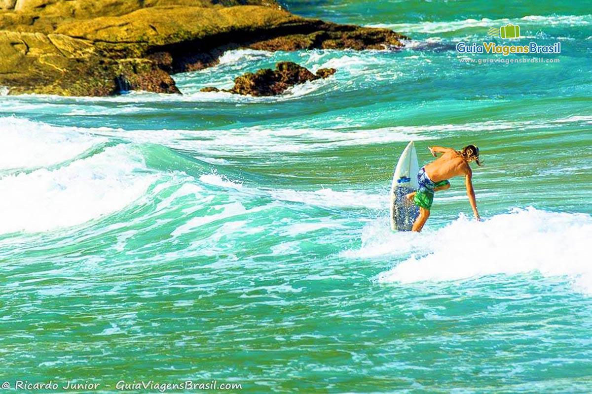 Imagem de surfistas fazendo manobra no mar da Praia José Gonçalves.