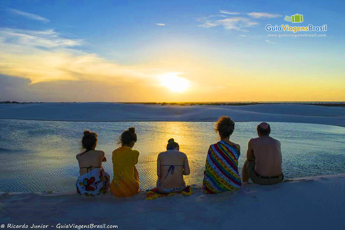 Imagem de turistas encantados com o belíssimo por do sol.