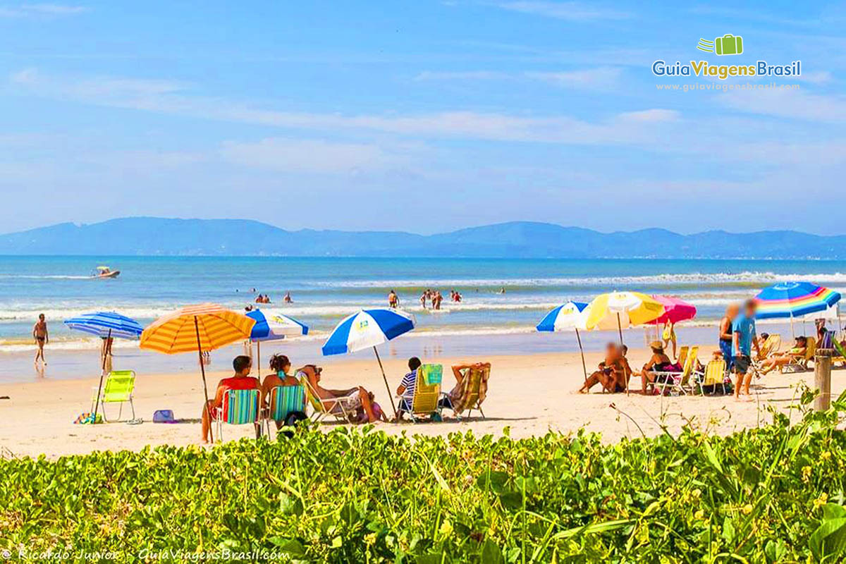 Imagem de turistas curtindo um lindo dia na Praia Itapema.